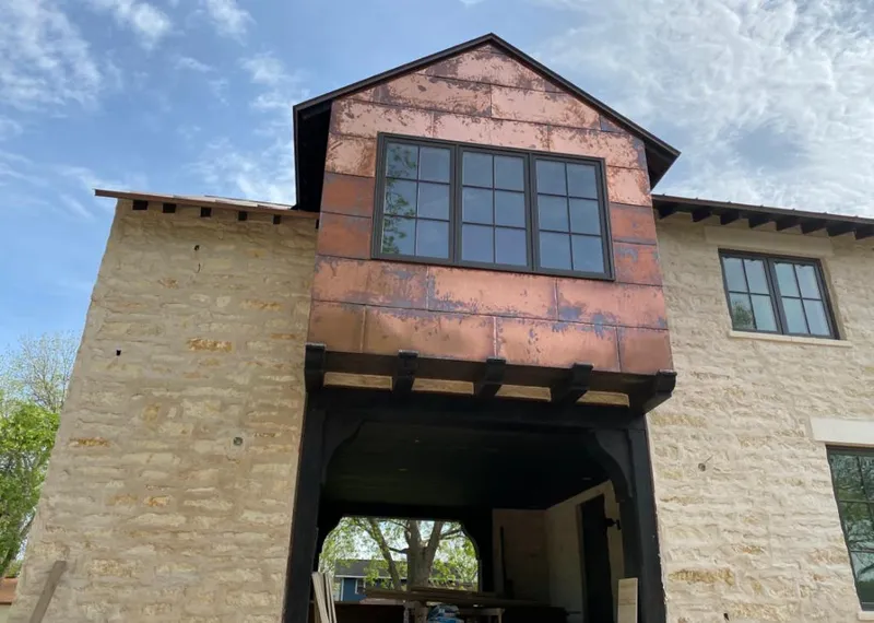 Copper metal panel facade on a stone building for Roof Repair in Jefferson City