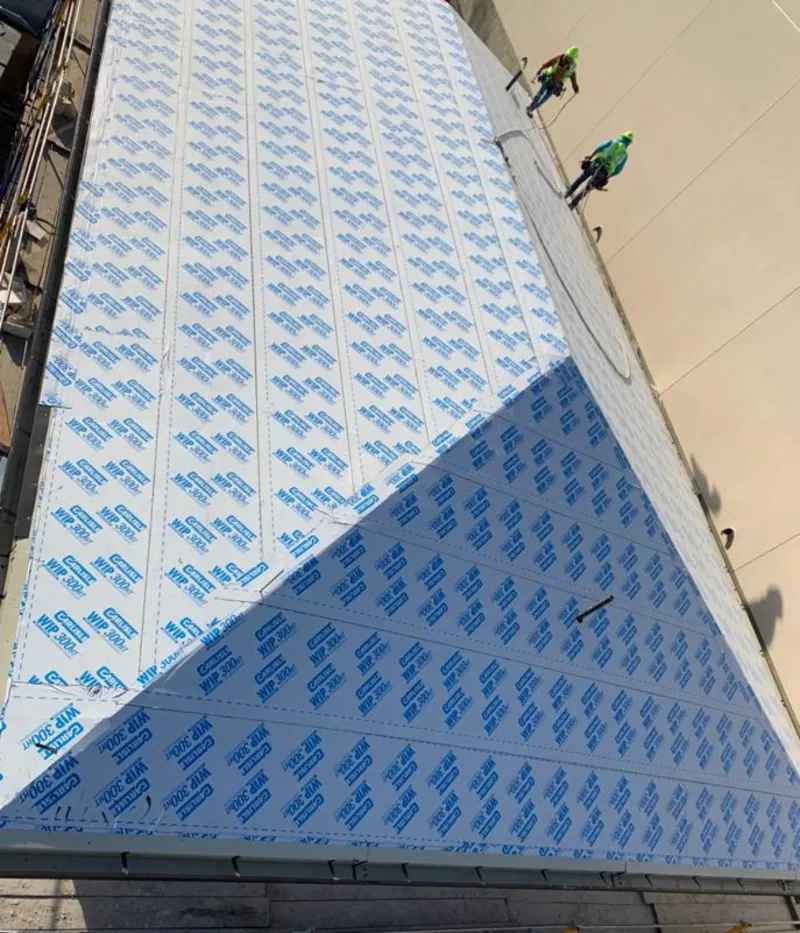 Professional roofers installing underlayment on a metal roof in Jefferson City